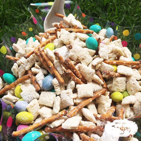 White Chocolate coated chex cereal mixed up with pretzel sticks and M&Ms makes this Easter Bunny Chow Recipe thats sure to be a sweet, snacky hit with everyone at the table!
