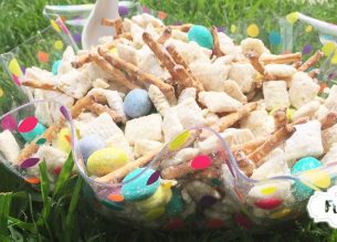 White Chocolate coated chex cereal mixed up with pretzel sticks and M&Ms makes Easter Bunny Chow thats sure to be a sweet, snacky hit with everyone at the table!