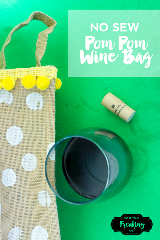 Dress up your wine with this pom pom trimmed DIY New Sew Wine Gift Bag! Easy beginner craft to do in 30 minutes or less. Classy and festive for summer parties!