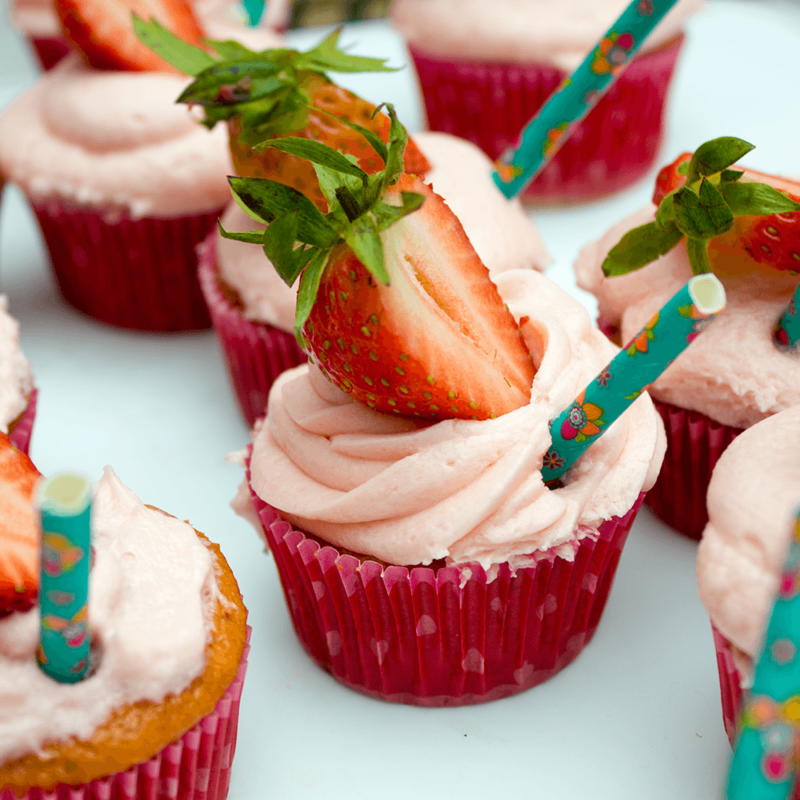 Cute Strawberry Lemonade Cupcakes are the perfect addition to a summer brunch or cook out! Tangy, sweet and easy to make! No one will know they're from a box mix!