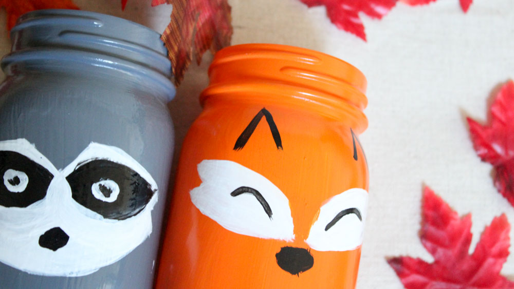 Simple DIY Fox and Raccoon Woodland Creatures painted mason jars for your kids room or fall decor!
