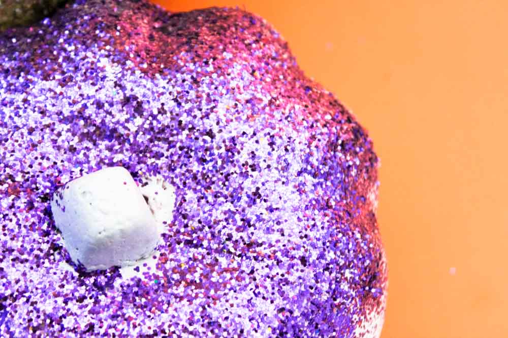 Transform foam pumpkins from the dollar tree into chic DIY Glitter Pumpkins for you halloween and fall decor!