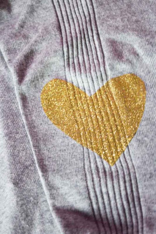 Breathe new life into an old sweater with a quick DIY Glitter Heart Elbow Patch! Simply cut out and iron in the desired location and you've got a whole new look! - Heart Patch Sweater | Elbow Patch | DIY Upcycle | Cardigan | Valentines - Do It Your Freaking Self