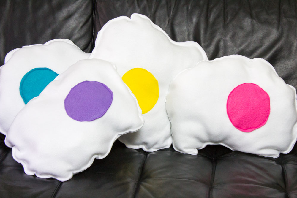 Add some comfy fun to your couch this spring with some DIY rainbow fried egg pillows! Easy sewing tutorial to make your own custom food throw pillow!