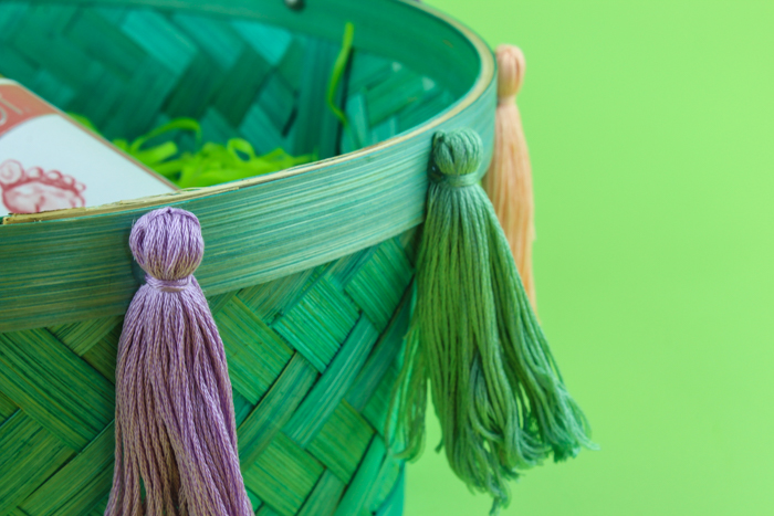 Spruce up a simple basket for your own DIY Tassel Basket for Easter! Perfect for a grown up look with all the fun you remember when you were a kid!
