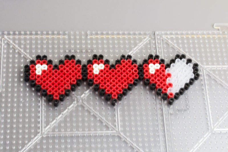 Let your geek flag fly with a DIY Legend of Zelda Pixel Heart Statement Necklace. Pull out some perler beads and your nintendo and party like it's 1986.
