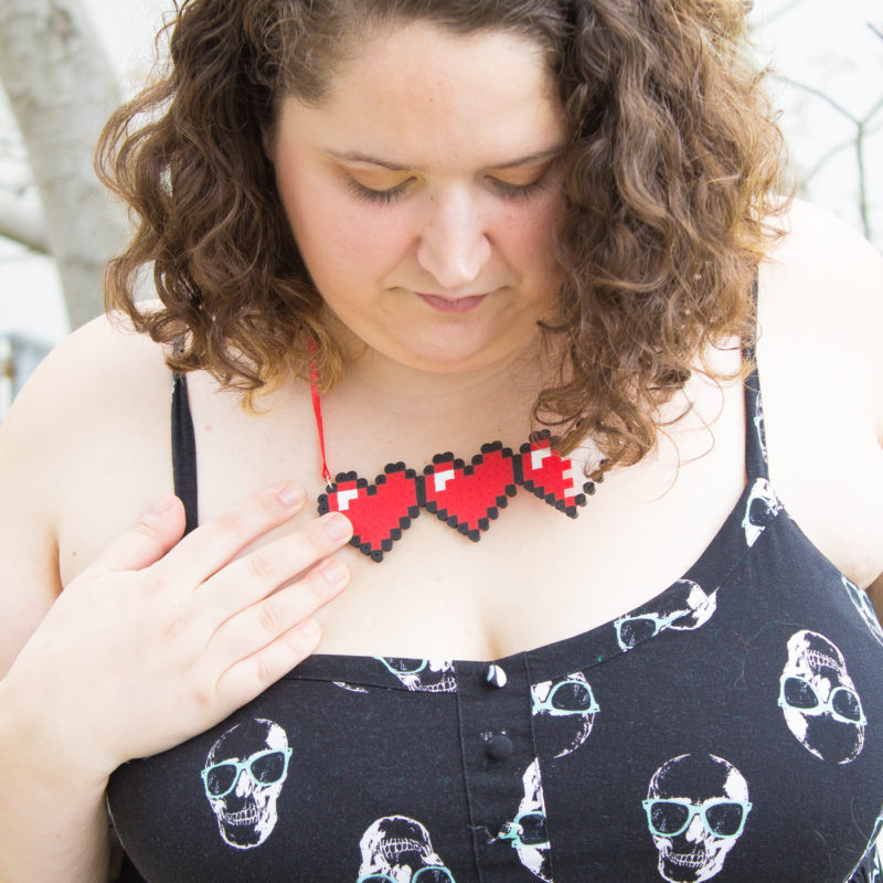 Let your geek flag fly with a DIY Legend of Zelda Pixel Heart Statement Necklace. Pull out some perler beads and your nintendo and party like it's 1986.