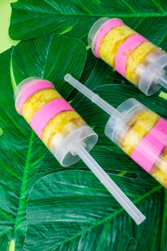 Kick off your summer luau by making these fun boozy tropical cake push pops! A sweet addition to your flamingo, pineapple, hawaiian party! Flamingo pineapple party | Luau food | treat pops | Cake pops | pink and yellow 