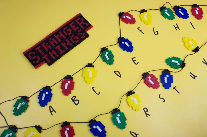 Get ready for Stranger Things Season 2 or just show off your knowledge of the Upside Down with this easy Perler Bead Stranger Things Banner. | Fusion beads | #Strangerthings | perler bead pattern | Christmas Lights | DoItYourFreakingSelf.com