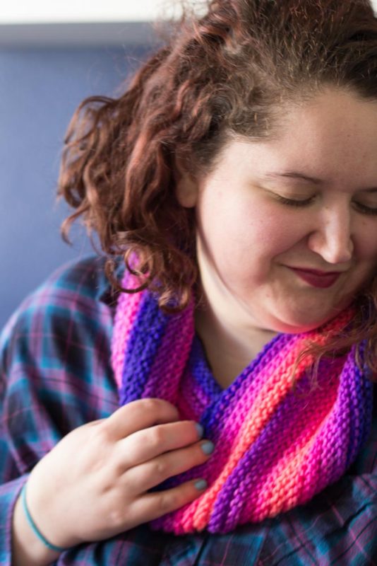 Knit with straight needles, this knit gradient cowl scarf is perfect for beginner knitters learning new stitches. Grab your favorite yarn and get knitting!