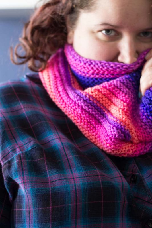 Knit with straight needles, this knit gradient cowl scarf is perfect for beginner knitters learning new stitches. Grab your favorite yarn and get knitting!